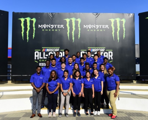 Interns pose at a NASCAR event