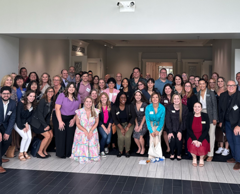 A large group of more than 40 PR professionals posing for a photo at media mashup 2023